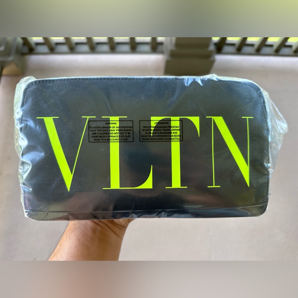 New Valentino VLTN leather belt bag with printed logo in bright yellow.